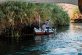 Two friendly fishermen who are greeting us from their small boat on the Nile river