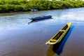 Two fishing canoes and a boat standing on the River