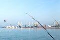 Two fishing rods on the beach against the background of the sea Royalty Free Stock Photo