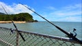 Two fishing rods on Palm Cove pier Queensland Australia Royalty Free Stock Photo