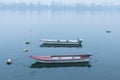 Two fishing and rowing boats on Zemun Quay Zemunski kej on a foggy dusk in winter over the Danube river, Belgrade in Serbia Royalty Free Stock Photo