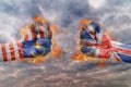 Two fist with the flag of Malasya and Great Britain faced at each other Royalty Free Stock Photo
