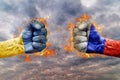 Two fist with the flag of Russia and Ukraine faced at each other