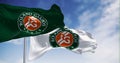 Two flags with the Roland-Garros logo waving in the wind