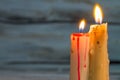 Two flaming candles on wooden background with copypace.