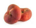 Two flat donut peaches isolated on a white background Royalty Free Stock Photo