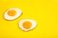 Two flawless frie egg on the yellow background