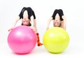 Two flexible teen girls doing gymnastics exercises on fitness Royalty Free Stock Photo