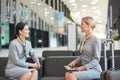 Two Flight Attendants Chatting in Waiting Lounge Royalty Free Stock Photo