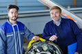 Two flight engineers posing in large aircraft hangar Royalty Free Stock Photo