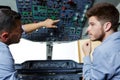two flight engineers talking in cockpit Royalty Free Stock Photo