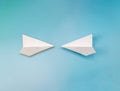 Two flying paper airplane crashing to each other