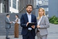 Confident business professionals standing outside office building Royalty Free Stock Photo