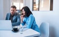 Two focused businesspeople working on a laptop in an office Royalty Free Stock Photo