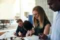 Focused coworkers discussing business together in a modern office