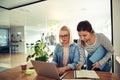 Two young businesswomen working together at an office desk Royalty Free Stock Photo