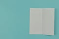 Two folded blank paper leaflet on blue background Royalty Free Stock Photo