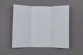 Two folded blank paper leaflet on grey background Royalty Free Stock Photo