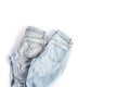 Two folded pairs of jeans in light blue on a white background. space for text, flat lay, top view Royalty Free Stock Photo