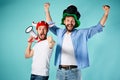 The two football fans with mouthpiece over blue Royalty Free Stock Photo