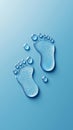 Two footprints made of water droplets appear on a smooth blue background, creating a refreshing and creative visual. The droplets Royalty Free Stock Photo