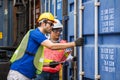 Two foremen with laptop opening Containers box door checking products from Cargo freight ship at Cargo container shipping