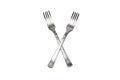 Two forks folded in a cross, isolated on white background Royalty Free Stock Photo