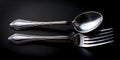 Two Forks and a Spoon on a Black Background Royalty Free Stock Photo