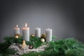 Two of four candles are burning for the second Advent on fir branches with Christmas decoration against a grey background, copy Royalty Free Stock Photo