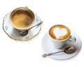 Two fragrant cups of coffee on a saucer with silver vintage spoon isolated on white background. Espresso macchiato and black coffe