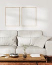 two frames mock up on white wall with sunlight in living room interior with gray sofa and coffee table with decor, 3d