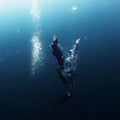 Two free divers ascending from the depth