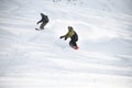 Two freeriders sliding down the mountain slope