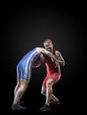 Two freestyle wrestlers figting isolated on black background Royalty Free Stock Photo