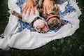 Two french bulldog dogs lying upside down outdoors