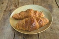 Two french traditional croissants on the plate