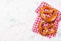 Two pretzels on a checkered towel, beer snack, top view with copy space Royalty Free Stock Photo