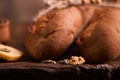 Two Fresh baguettes on dark wooden table. Selective focus Royalty Free Stock Photo