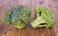Two fresh broccoli on a wooden surface Royalty Free Stock Photo