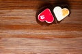 two fresh cakes, red and white, heart shapes on wooden background. Love delicious cakes. Royalty Free Stock Photo