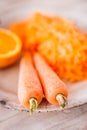 Two fresh carrots and a pile of grated carrot and half an orange Royalty Free Stock Photo