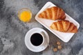 Two fresh croissants, orange juice and cup of coffee for breakfast Royalty Free Stock Photo