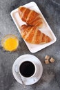 Two fresh croissants, orange juice and cup of coffee for breakfast Royalty Free Stock Photo