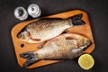 two fresh crucian carp lie on a cutting board