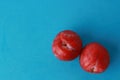 Fresh delicious plums on a blue surface Royalty Free Stock Photo