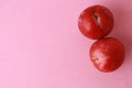 Fresh delicious plums on a pink surface Royalty Free Stock Photo