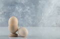 Two fresh eggs in eggcup and ground on white background Royalty Free Stock Photo
