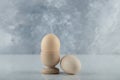 Two fresh eggs in eggcup and ground on white background Royalty Free Stock Photo
