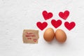 Two eggs with red hearts on white background with inscription Valentines day concept Royalty Free Stock Photo