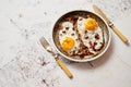 Two fresh fried eggs with crunchy crisp bacon served on rustic plate Royalty Free Stock Photo